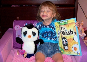 A very happy medically fragile Girl with our book & toy " Cory"