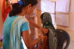 A young trainee draws blood.