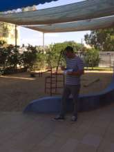 Taking mesurements of the playground for the plans