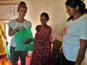 A pregnant woman receives an Outreach Mommy Kit.