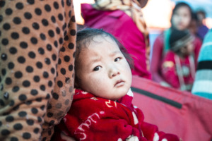 A baby rests while her mother attends awareness