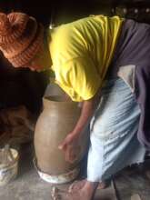 women making Nadi pots at household level