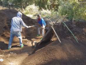 Our team sieves the soil for our seedling pots