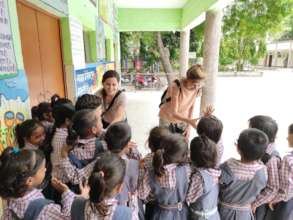 Girls interacting with Harvard University student