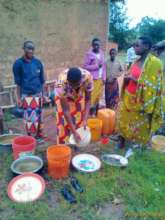 Untencils women filling drinking water from canal