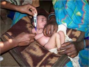 Village Health worker (VHW) examining a child