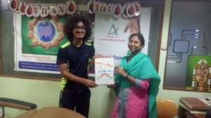 Dr. Sarita presenting artwork to Chaitanya