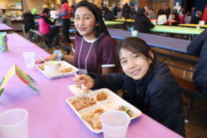 Two students enjoy Lummi Island Wild Salmon Cakes