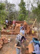 Community effort moving adobe bricks for building
