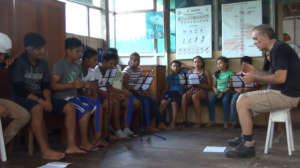 Jose teaching songs on recorder at the library