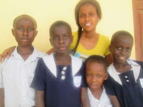 Mary with her class teacher some PAAJAF kids