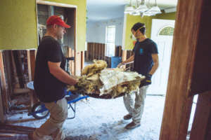 Volunteers cleaning up destroyed houses