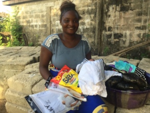 Fatmata with her clothes and toiletries for sale