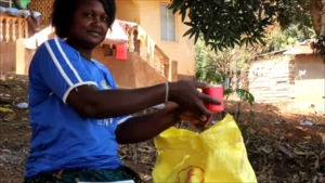 Hawa shows us a cup of rice