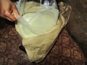 she shows us the open bag of powdered milk