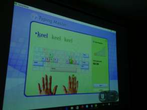 ladies learning how to type using a typing tutor