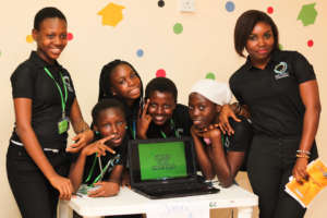 Girls from the W.TEC Camp show off their project.