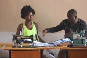 Alusine, an instructor at the tailoring school