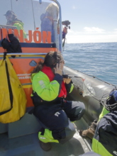 A volunteer listens for whale calls