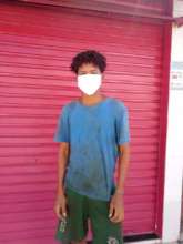 Community member receiving a mask donated by VAV