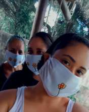 Priscila wearing one of her a hand-painted masks