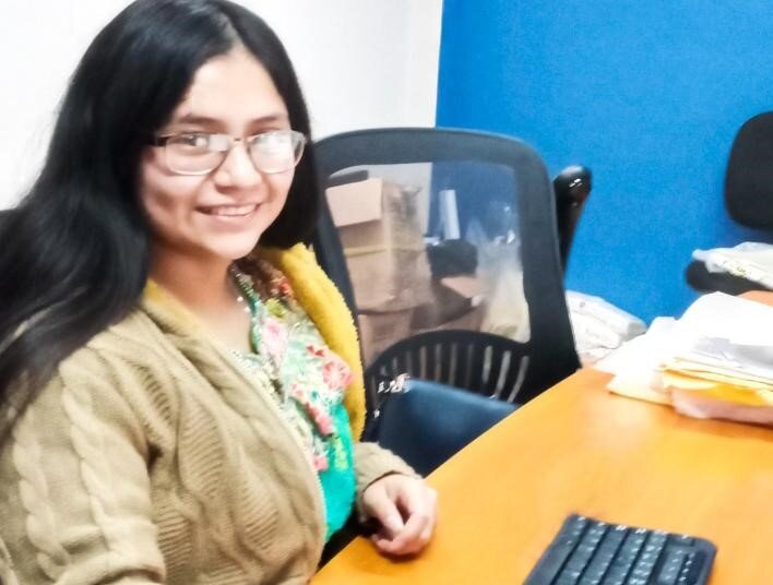 Deysi at her desk in the accounting office.