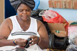 Lady Stitching a shoe 2