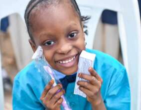 Our smiling friend with her tooth brush and paste.