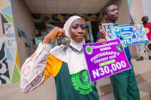 Hadiza with her medal and a cash prize.