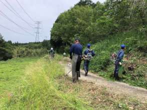 Grass cutting with the local villagers.