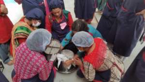Women learning to make various items from milk.