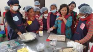 Women learning to make various items from milk.