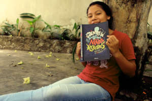 Migdalia reads "Goodnight Stories for Rebel Girls"
