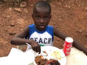 Dream Home child, Derick, enjoying a meal