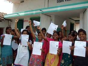 Pupils from Dhobi school with exam pass papers