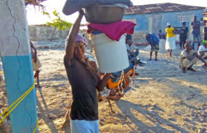 A woman receives a distribution on La Gonave