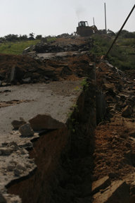 Israeli Army bulldozer ripping Peace Road apart