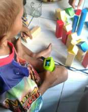 Fadil plays with his toys during his checkup