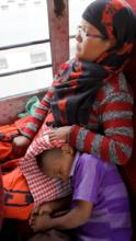 An exhausted child on his way home to Nepal
