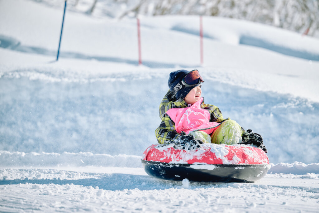 Camper Enjoying Snow Tubing