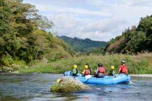 Kids rafting down a peaceful river in nature