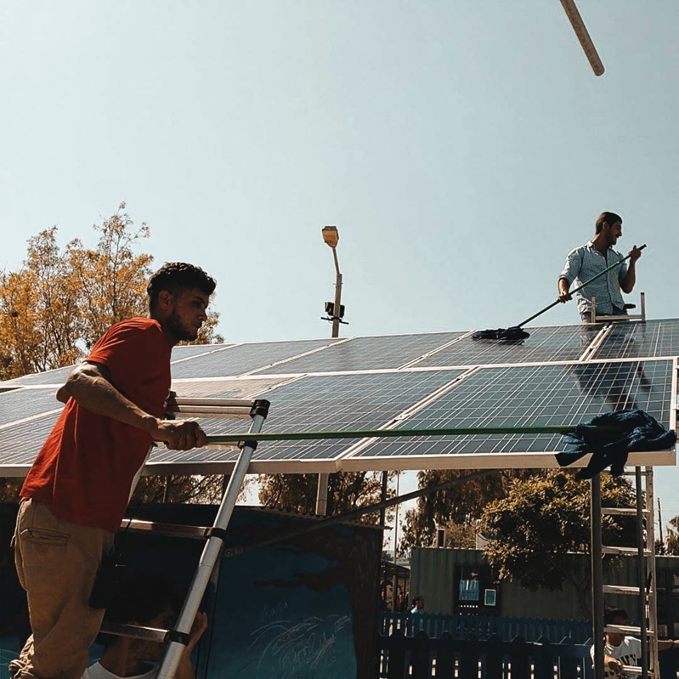 Our electricity team cleaning the solar panels!
