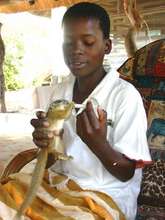 Underprivileged child feeds tree squirrel