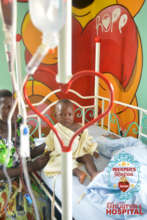 Sick child receiving blood transfusion
