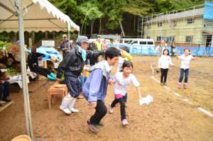 Children participating in sport event with locals