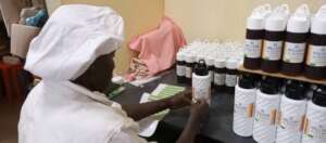 Paul labelling the bottles of honey