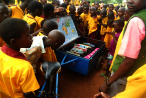 Nambi Sseppuuya mobile library arrives at school.