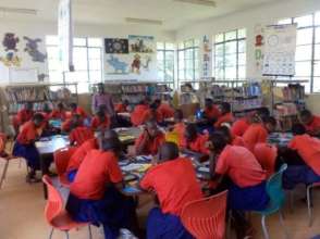 Children explore the new books in Dzitsoni library