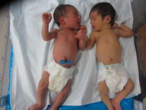 The twins stretch their arms for the first time