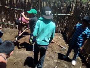 Grade 5  students helping to construct garden